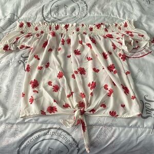 Over-the-shoulder, floral and dressy top.